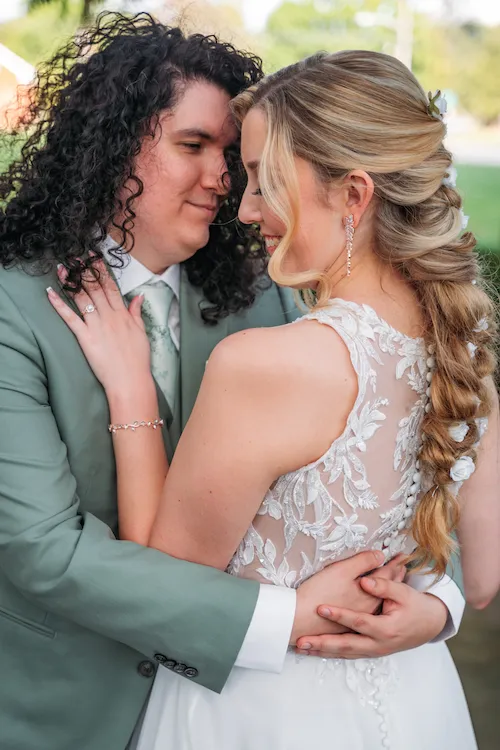 groom holding bride while she's smiling