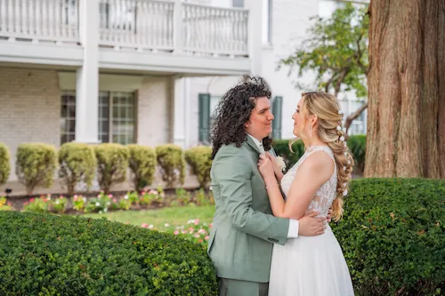 bride and groom smiling at each other
