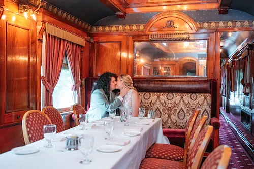 bride and groom inside vintage train car at the madison hotel