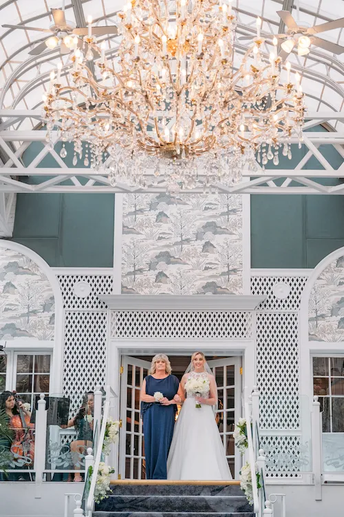 Bride walking with mom down the aisle at the Madison hotel Conservatory