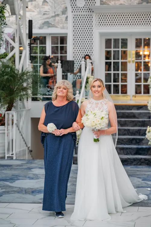 Bride walking with mom