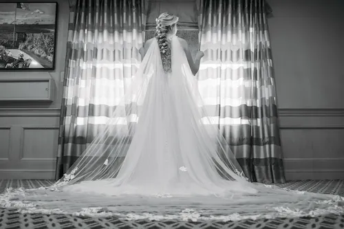Black and white shot of bridal gown from behind