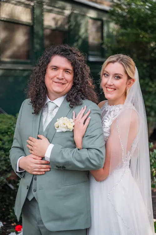 portrait of bride and groom in front of the madison hotel