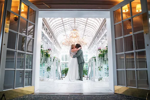 entrance to the conservatory with bride and groom at madison hotel