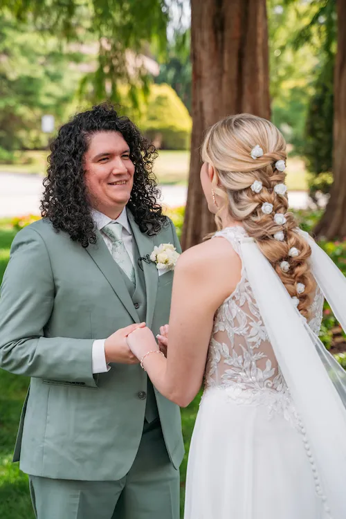 Groom smiling warmly at his bride during portraits