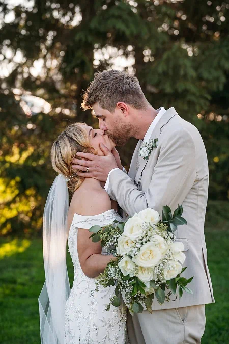 groom kissing bride sue ann winery