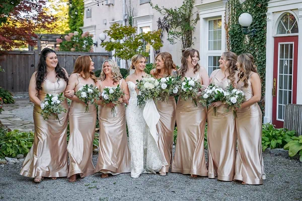 Bride laughing with bridesmaids at inn on the twenty