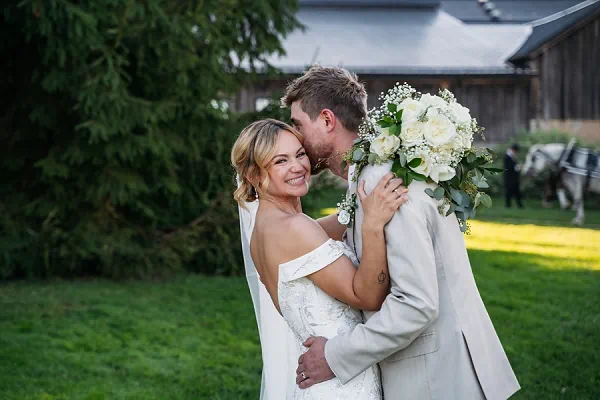 groom kissing bride while she laughs