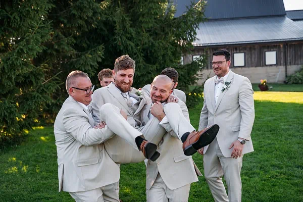 groomsmen lifting groom