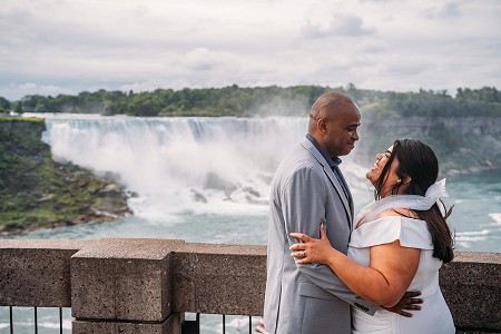 bride and groom with niagara falls in background
