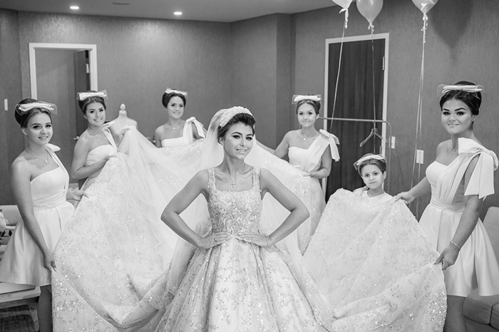bridesmaids helping bride with her dress at white oaks