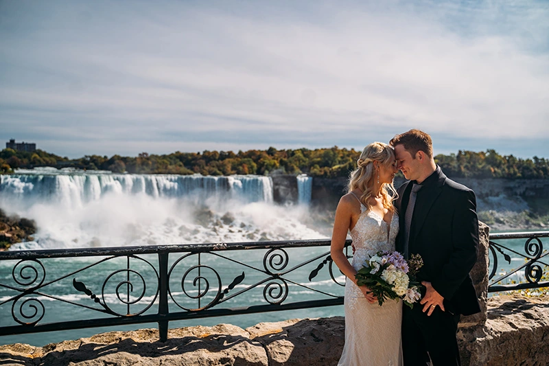  bride and groom kissing in front of Niagara Falls during their elopement