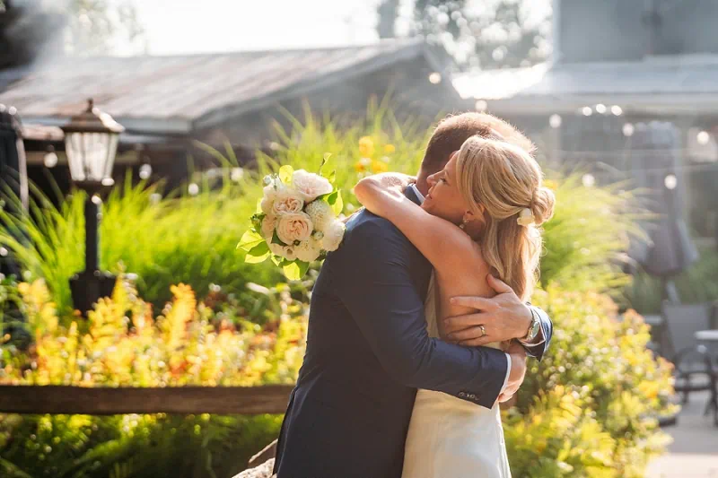 candid of bride hugging groom at Honsberger winery