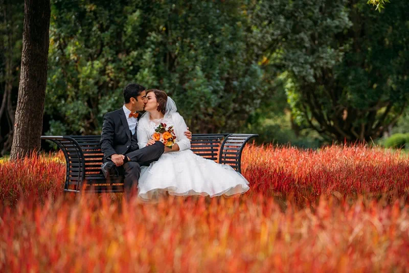bride and groom surrounded by flowers at pilar and post in NOTL